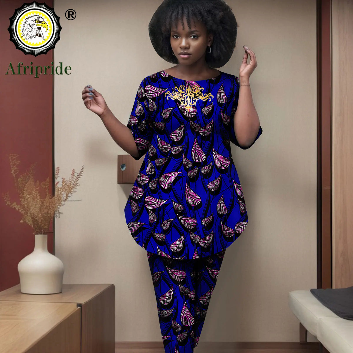 Woman wearing a blue and purple patterned dress with 'Afripride' branding.