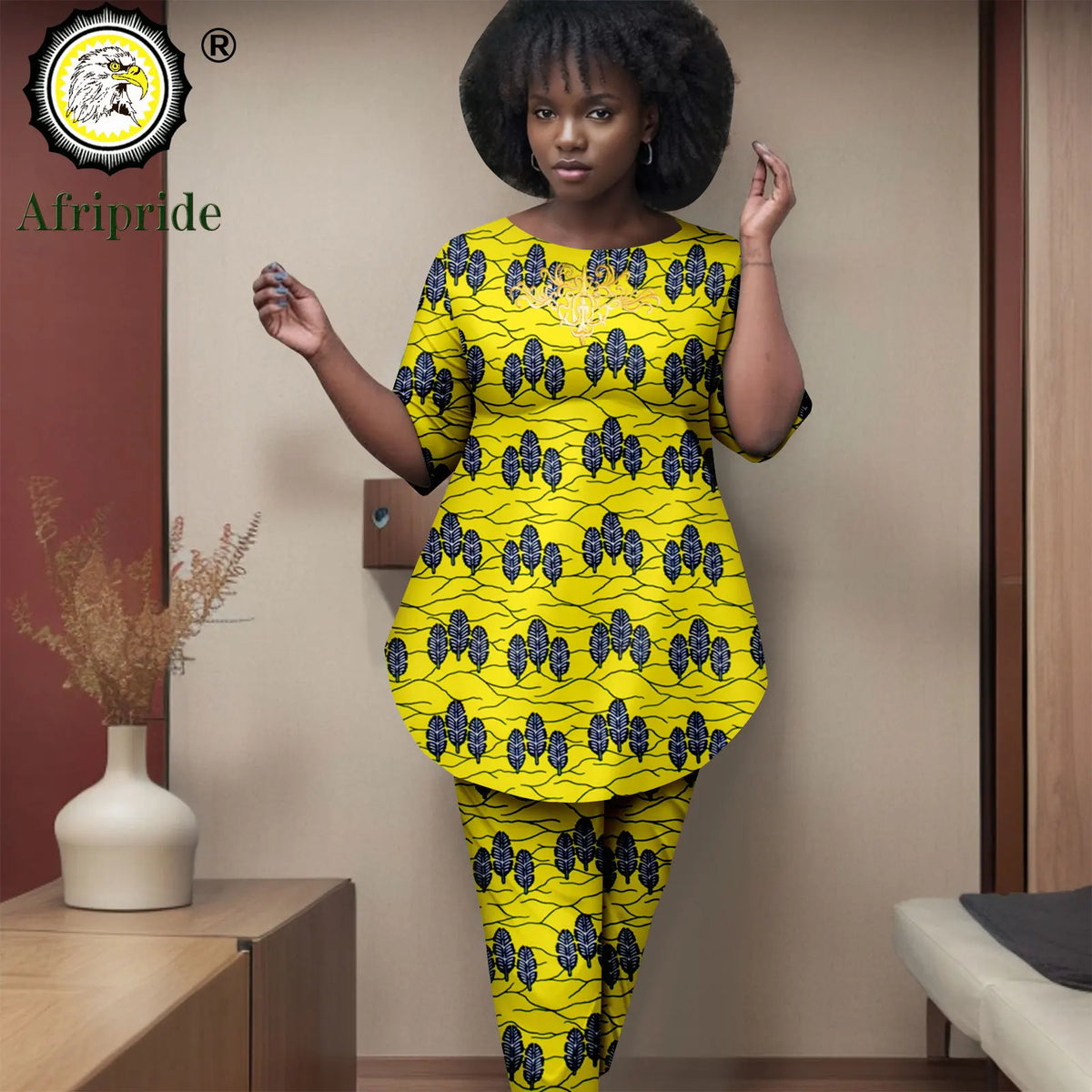 Woman wearing a yellow and black patterned outfit with 'Afripride' branding.